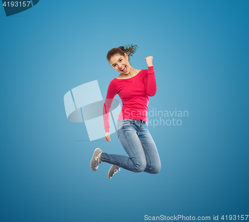 Image of smiling young woman jumping in air