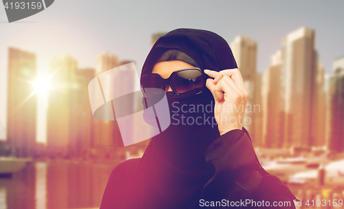 Image of muslim woman in hijab and sunglasses in dubai city