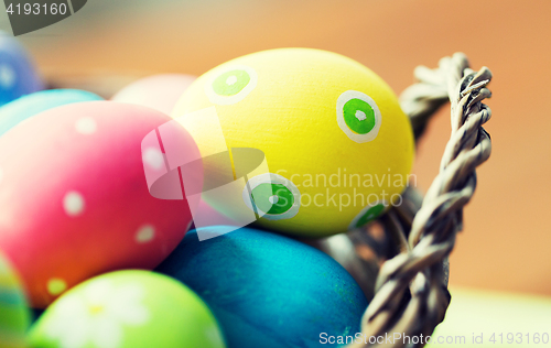 Image of close up of colored easter eggs in basket