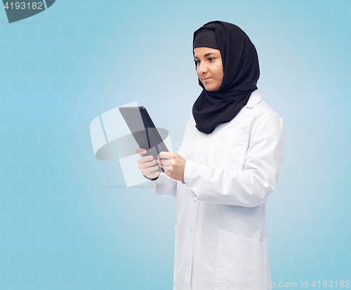 Image of muslim female doctor in hijab with tablet pc