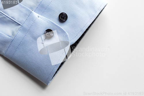 Image of close up of blue shirt sleeve