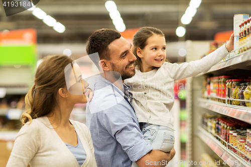 Image of happy family buying food at grocery store