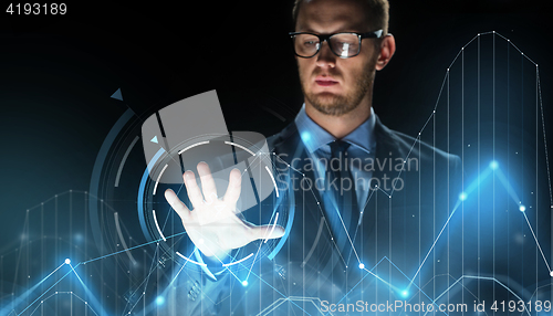 Image of businessman touching virtual charts projection