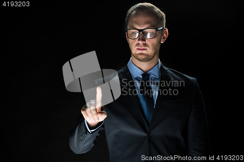 Image of close up of businessman touching virtual screen