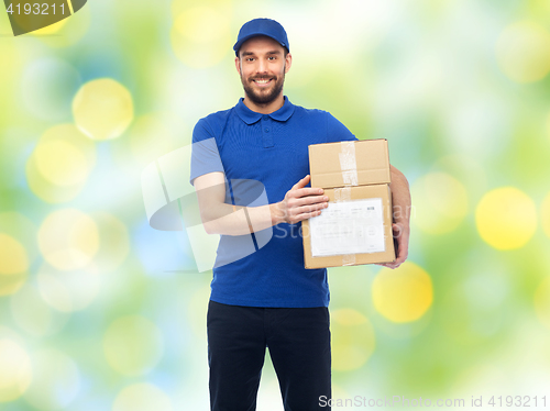 Image of happy delivery man with parcel boxes