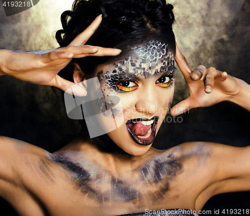 Image of fashion portrait of pretty young woman with creative make up like a snake, halloween