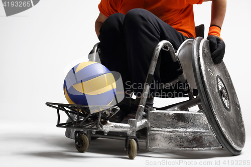 Image of Handball in a wheelchair The man on the sports wheelchair with the ball 