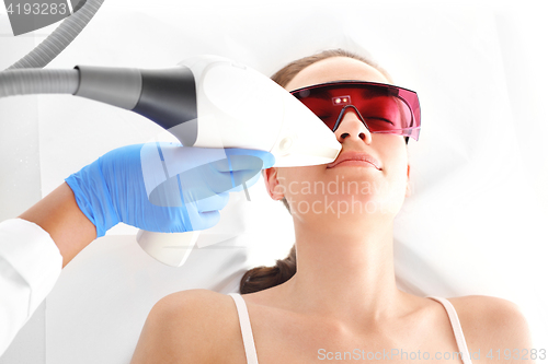 Image of Cosmetic clinic, a woman during laser hair removal facial