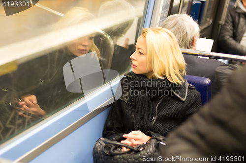 Image of Woman looking out metro\'s window.