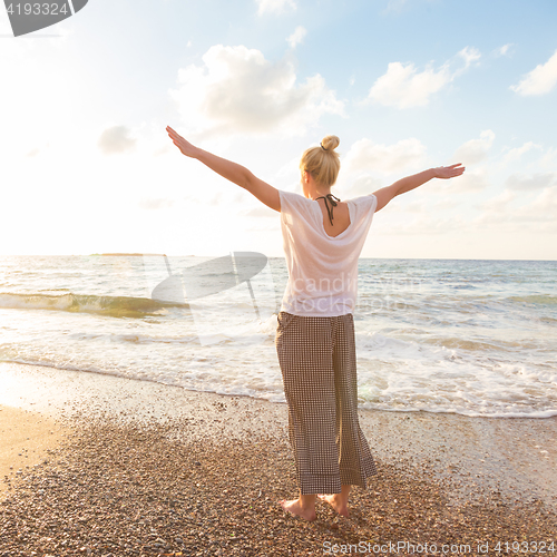 Image of Free Happy Woman Enjoying Sunset on Sandy Beach