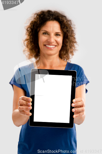 Image of Happy woman holding tablet