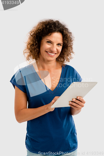 Image of Happy woman working with a tablet