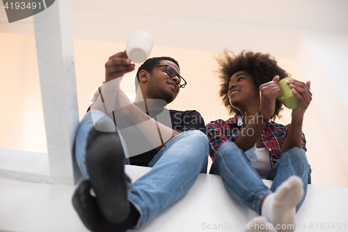 Image of couple having break during moving to new house