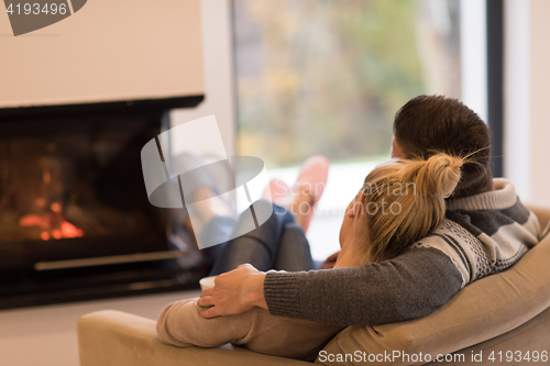 Image of Young couple  in front of fireplace