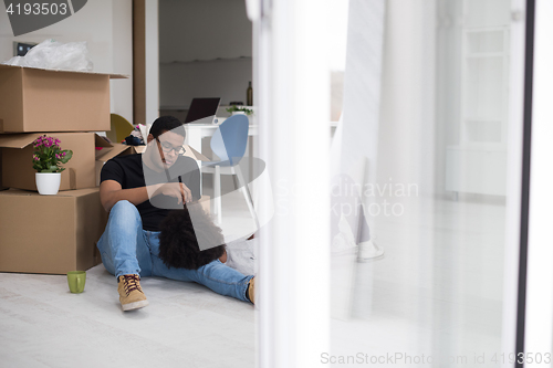 Image of African American couple relaxing in new house