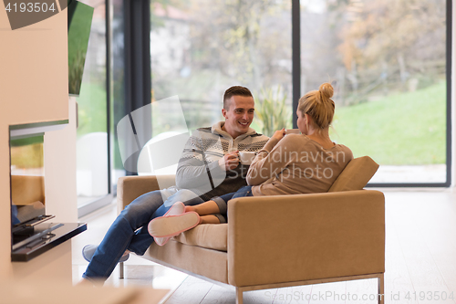 Image of Young couple  in front of fireplace