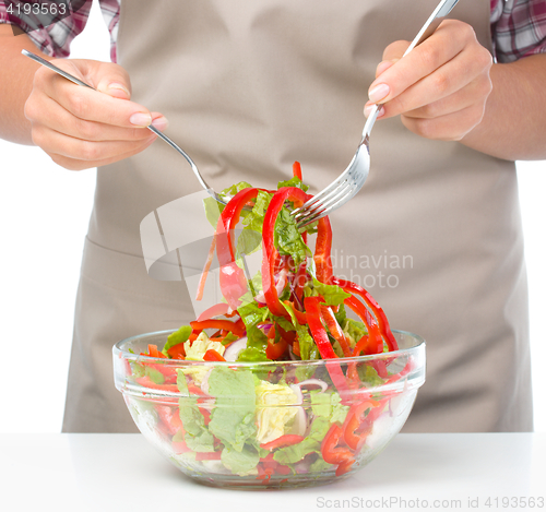 Image of Cook is mixing salad