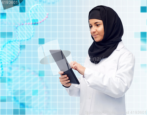 Image of muslim female doctor in hijab with tablet pc