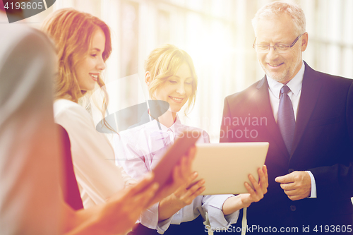 Image of business people with tablet pc computers at office