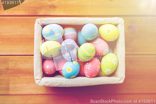 Image of close up of colored easter eggs in basket