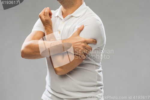 Image of close up of man suffering from pain in hand