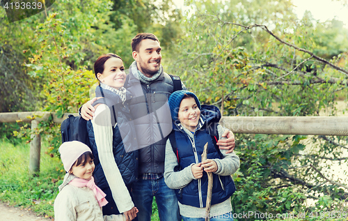 Image of happy family with backpacks hiking