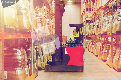 Image of man on forklift loading cargo at warehouse