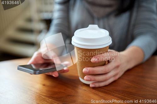 Image of close up of woman with smartphone and coffee