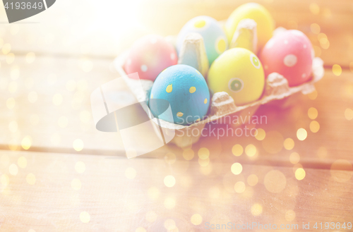 Image of close up of colored easter eggs in egg box