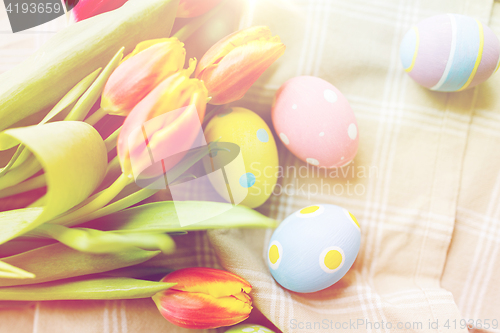 Image of close up of colored easter eggs and flowers