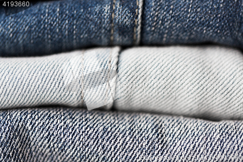 Image of close up of denim clothes or jeans pile