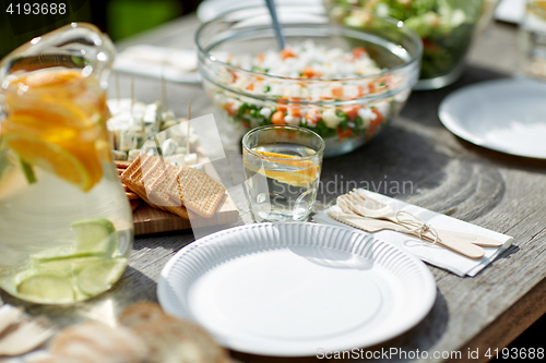 Image of table with food for dinner at summer garden party