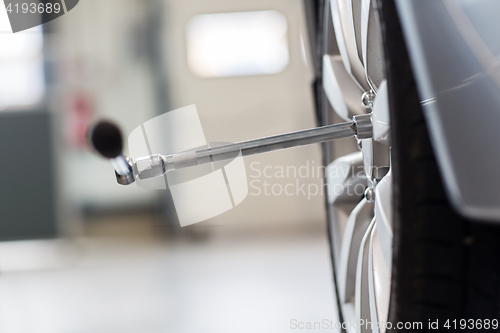 Image of screwdriver and car wheel tire