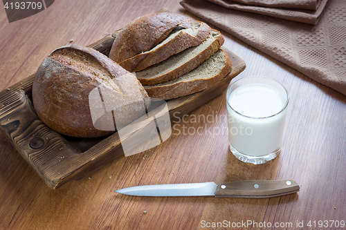 Image of Bread loaf and milk in glass