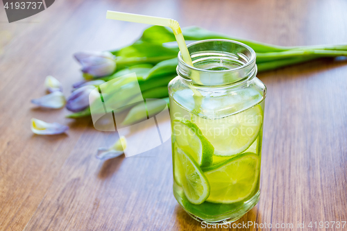 Image of Lime cocktail in jar and bouquet of tulips