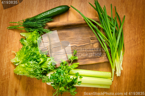 Image of Fresh greens and rustic wooden dish