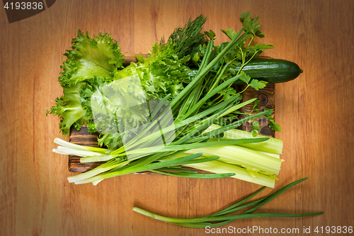 Image of Fresh vegetables and rustic wooden dish