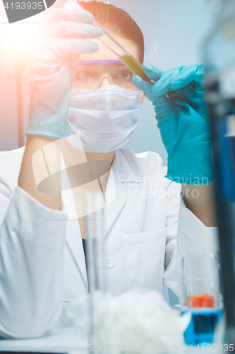 Image of Brunette working with test tubes