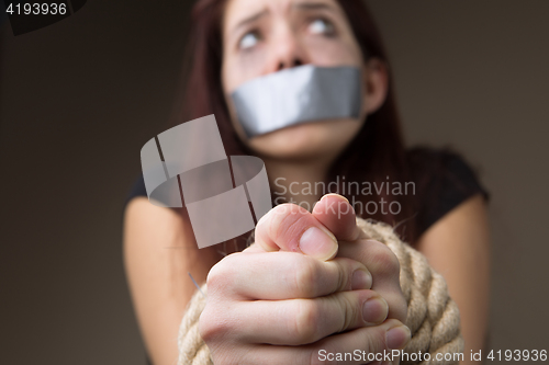 Image of Woman gagged and tied hands