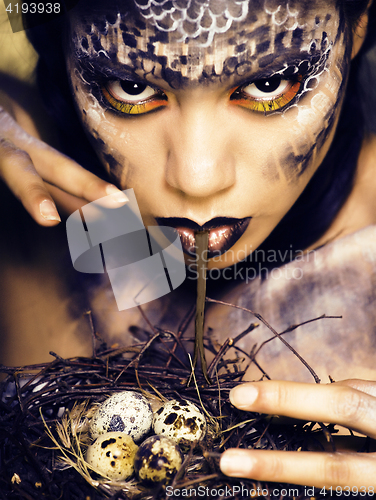 Image of fashion portrait of pretty young woman with creative make up like a snake, halloween