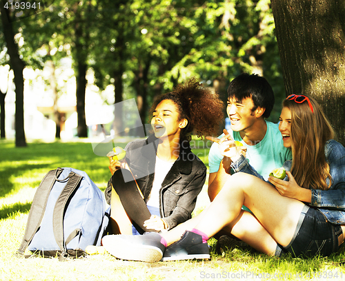 Image of cute group of teenages at the building of university with books huggings, diversity nations