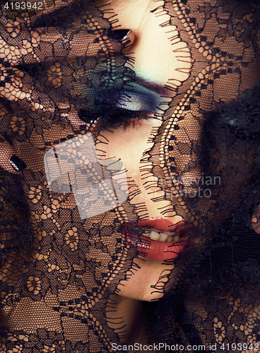 Image of portrait of beauty young woman through lace