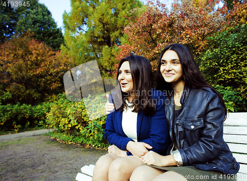 Image of mature real mother with daughter outside in park, recreation concept, lifestyle people 