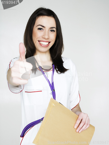 Image of young pretty woman doctor with stethoscope emotional posing, pointing in camers, lifestyle people concept 