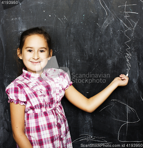 Image of liittle cute girl in classroom near blackboard, lifestyle people concept