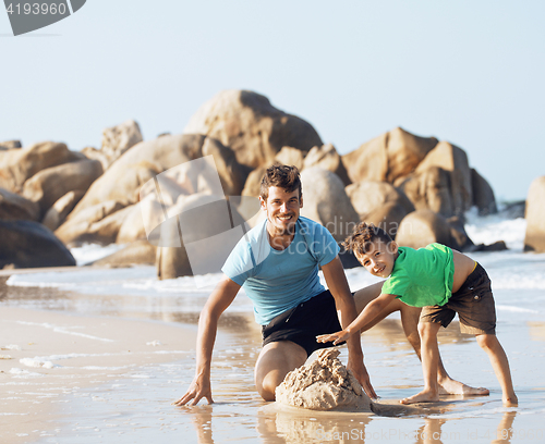 Image of happy family on beach playing, father with son walking sea coast