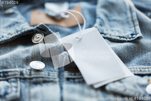 Image of close up of denim jacket with white price tag