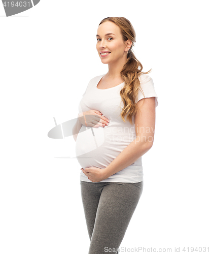 Image of happy pregnant woman touching her big belly