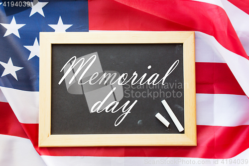 Image of memorial day words on chalkboard and american flag