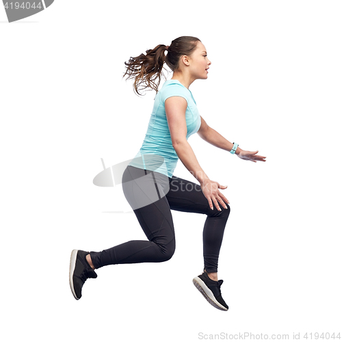 Image of happy smiling sporty young woman jumping in air